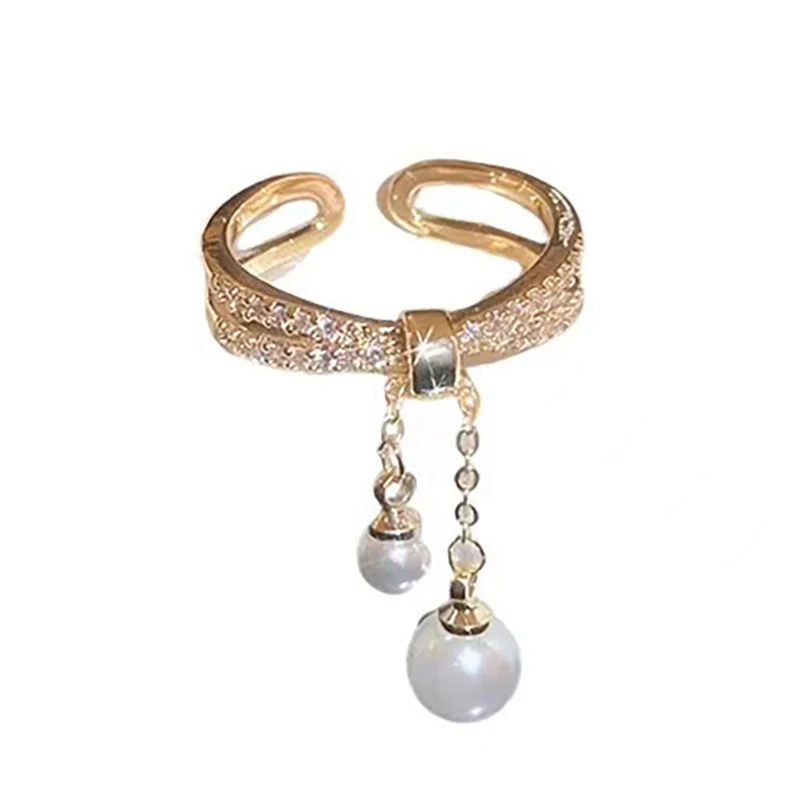 Bague avec perles pendantes dorée ajustable